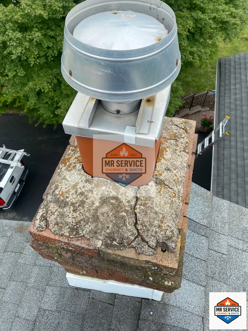Close view of deteriorated chimney crown and flue area