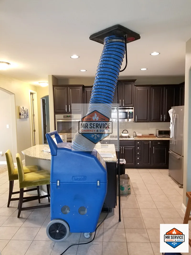Blue negative air machine and duct hose set up inside a home