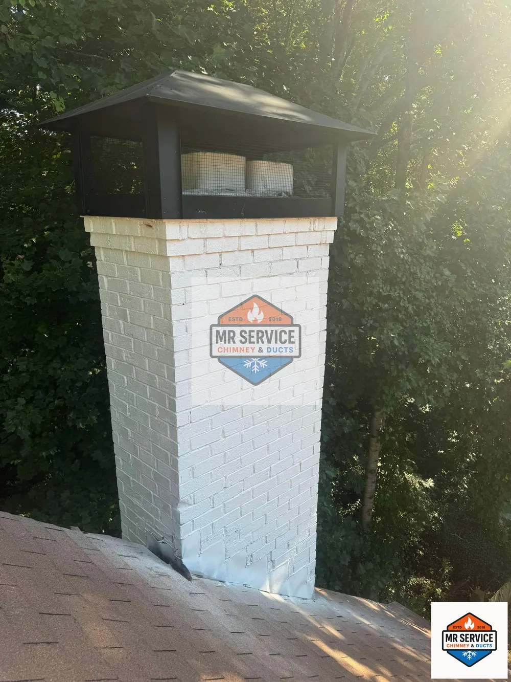 White brick chimney with a black protective cap